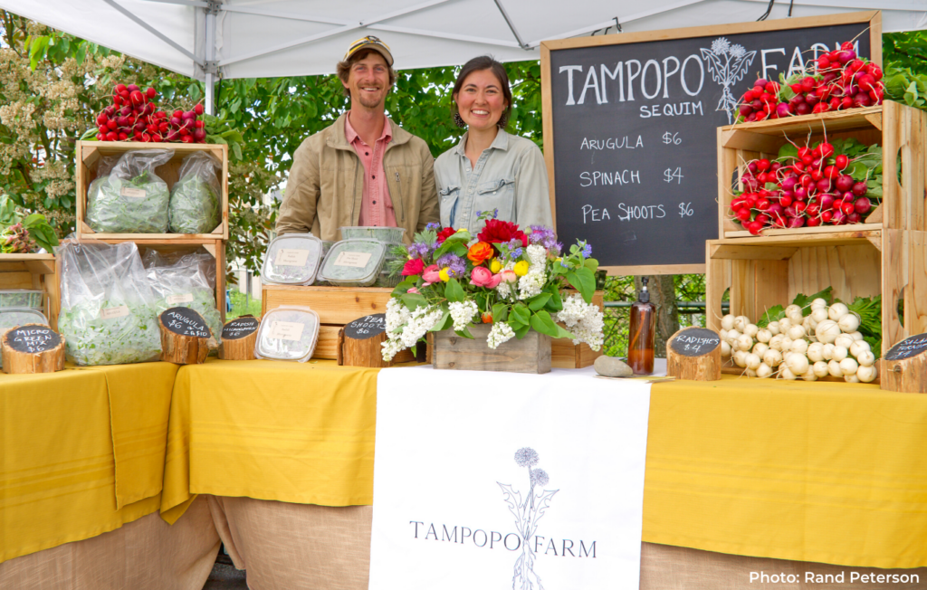 Teresa and Matt of Tampopo Farm with their booth and produce at the Phinney Farmers Market