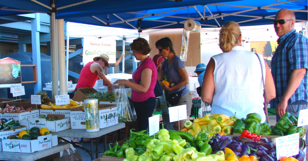 Shoppers talk and buy produce at the Phinney Farmers Market.
